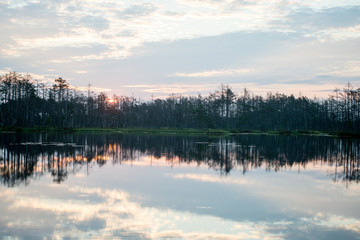 Fototapeta premium reflections in the lake water at sunrise