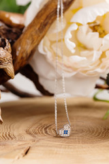 Fototapeta na wymiar Silver necklace with blue gem