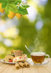 image of cups with tea and cookies on sunlight background closeup