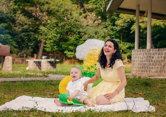 Mother showing off party decorations with baby