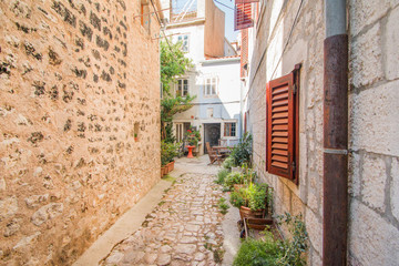     Narrow street and old houses in old town in Cres, Croatia, Mediterranean ambient 