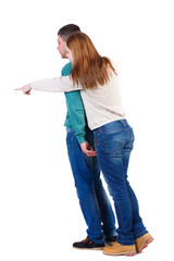 young couple pointing at wal Back view  (woman and man). Rear view people collection.  backside view of person.  Isolated over white background. A woman in a white blouse and hugged a man shows his