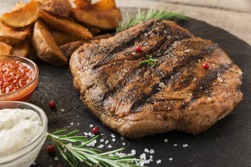 Beef steak with baked potato and sauce