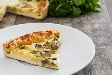 French quiche Lorraine with vegetables on a plate


