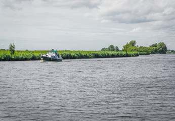 Fototapeta premium boat sailing in a river landscape 2