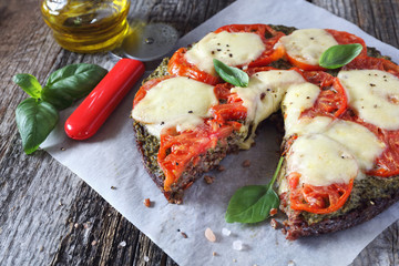 Eating gluten-free: pizza with mozzarella on a black rice