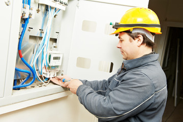 electrician connecting electricity counter meter in fuse box