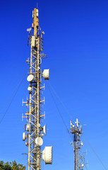 Communication antenna tower on blue sky