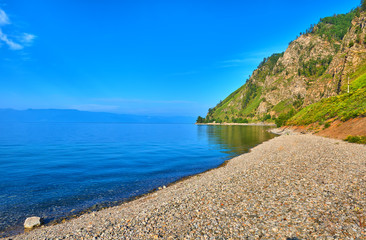 Fototapeta na wymiar Small pebbles on shore of Lake Baikal