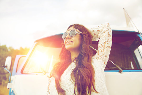 smiling young hippie woman in minivan car