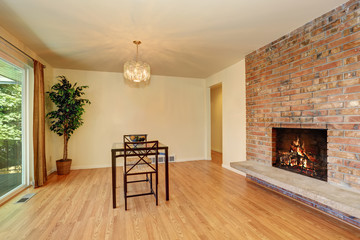 Nice dining room with hardwood floor and brick tile fireplace.