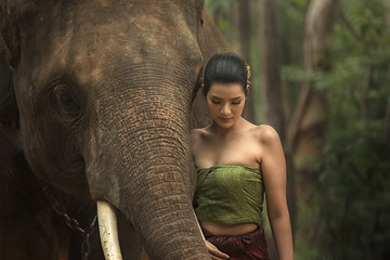 Asia woman and elephant with Thai culture traditional.