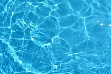Fototapeta na wymiar Water surface with a blue ripples