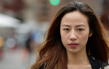 Obraz premium Young Asian woman in city serious face portrait