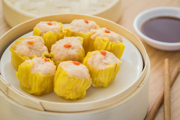 Steamed dumplings in bamboo steamer basket