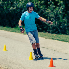 Senior man roller skating in park