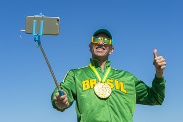 Gold medal athlete in Brazil jacket makes an excited face as he poses for a celebration picture