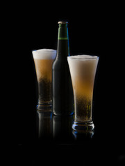 beer in a bottle and a glass on a dark background 