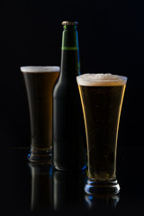 beer in a bottle and a glass on a dark background 