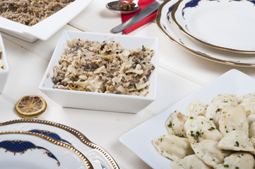 Noodles with cabbage and mushrooms in a white bowl on the table 