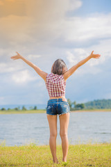 Back view of woman who standing with blue sky