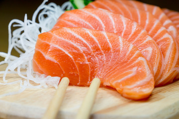 Salmon raw sashimi on wooden table