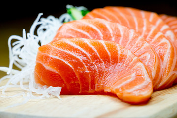 Salmon raw sashimi on wooden table