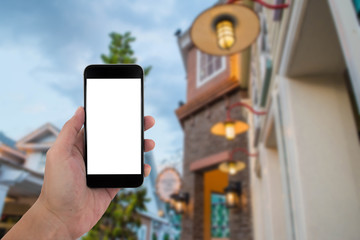 man hand holding the phone and white screen with blur background