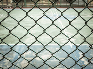 Fototapeta premium Color retro image, Outdoor sport court behind Green wired fence
