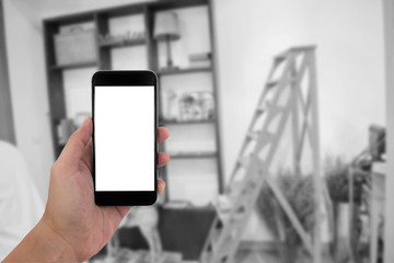 man hand holding the phone and white screen with blur black and