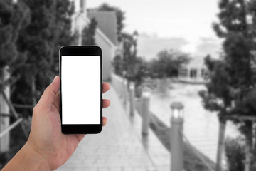 man hand holding the phone and white screen with blur black and