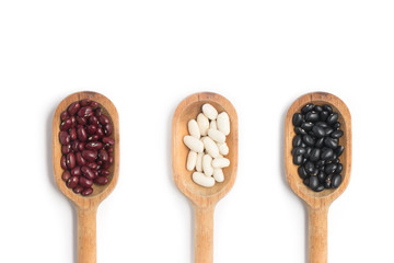 Raw Black, Red and White beans into a bowl in white background.