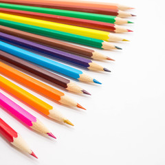 Multicolored pencils on white background. Schoolchild and student studies accessories. Back to school concept.