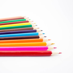 Multicolored pencils on white background. Schoolchild and student studies accessories. Back to school concept.