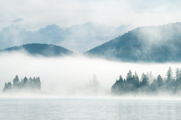 Heavy fog in the early morning on a mountain lake
Early morning on Yazevoe lake in Altai mountains, Kazakhstan  - 117923698