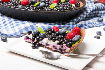 Delicious tart with blueberries and raspberries