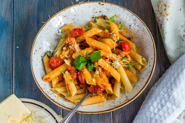 Penne pasta and arrabbiata sauce with cherry tomatoes
