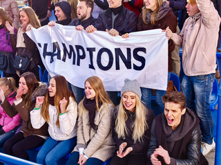 Sport fans holding champion banner and singing on tribunes. Group people. - 117924873
