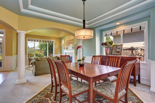 Dining room interior with mint walls and coffered ceiling.