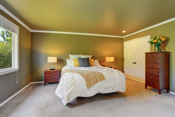 Gray bedroom interior with chest of drawers and fresh flowers