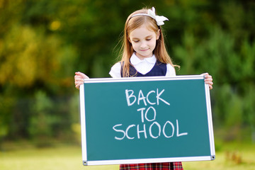 Adorable little girl feeling excited about going back to school