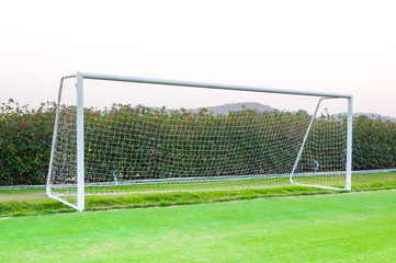 Fototapeta premium Goal shot from the corner in the front ,soccer field,empty amateur football goal posts and nets