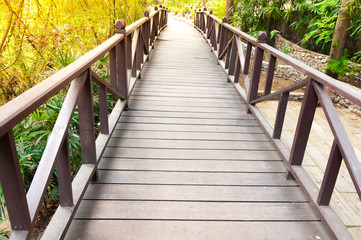 Fototapeta na wymiar Old charming wooden bridge in park