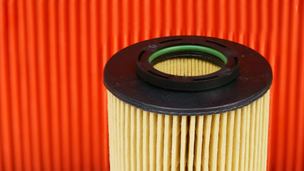 New car oil filter on the background of the air filter