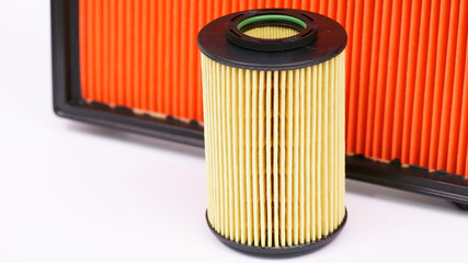 New car oil filter on the background of the air filter