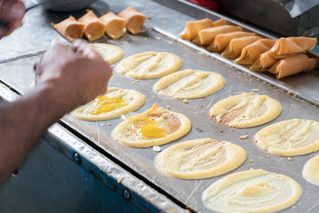 cooking rolling pancake (Khanom Tokyo) thin flat pancake filled with sweet custard cream