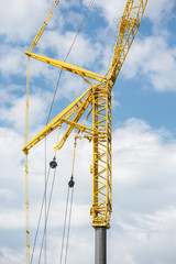 Large telescopic crane against cloudy sky