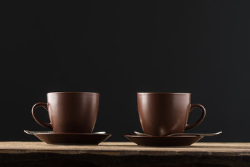 coffee cups, beans and sugar on rustic wooden table background
