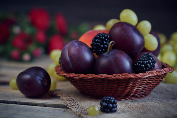 Mix of fresh berries and fruits on rustic wooden background