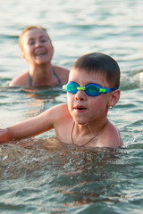 grandmother with her grandson bathing in the sea